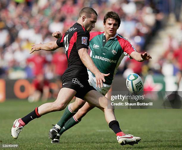 Frederic Michalak of Toulouse kicks the ball as Harry Ellis of Leicester looks on during the Heineken Cup Semi Final match between Leicester Tigers...