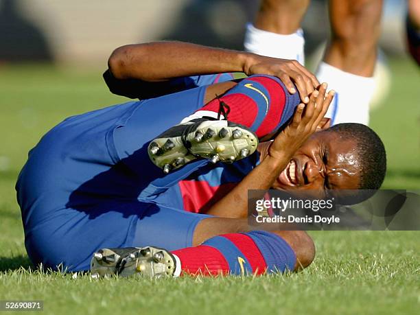 Barcelona`s Samuel Eto?o holds his knee after taking a knock during a La Liga soccer match between Malaga and Barcelona at the Rosaleda stadium on...