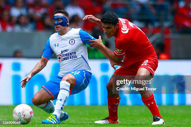 Francisco Gamboa of Toluca fights for the ball with Chistian Gimenez during the 16th round match between Toluca and Cruz Azul as part of the Clausura...