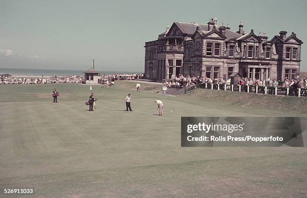 View of players and golfers on the 18th Green with the clubhouse behind on the Old Course at St Andrews in Fife, Scotland in summer 1955.