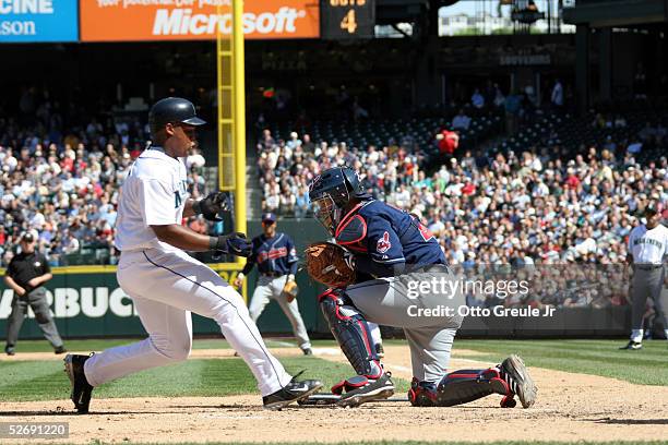 Adrian Beltre of the Seattle Mariners scores against catcher Josh Bard of the Cleveland Indians in the sixth inning on April 24, 2005 at Safeco Field...