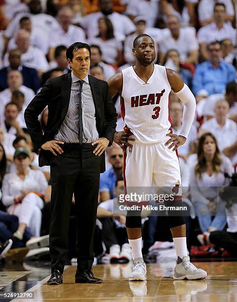 Head coach Erik Spoelstra and Dwyane Wade of the Miami Heat look on during Game Seven of the Eastern Conference Quarterfinals of the 2016 NBA...