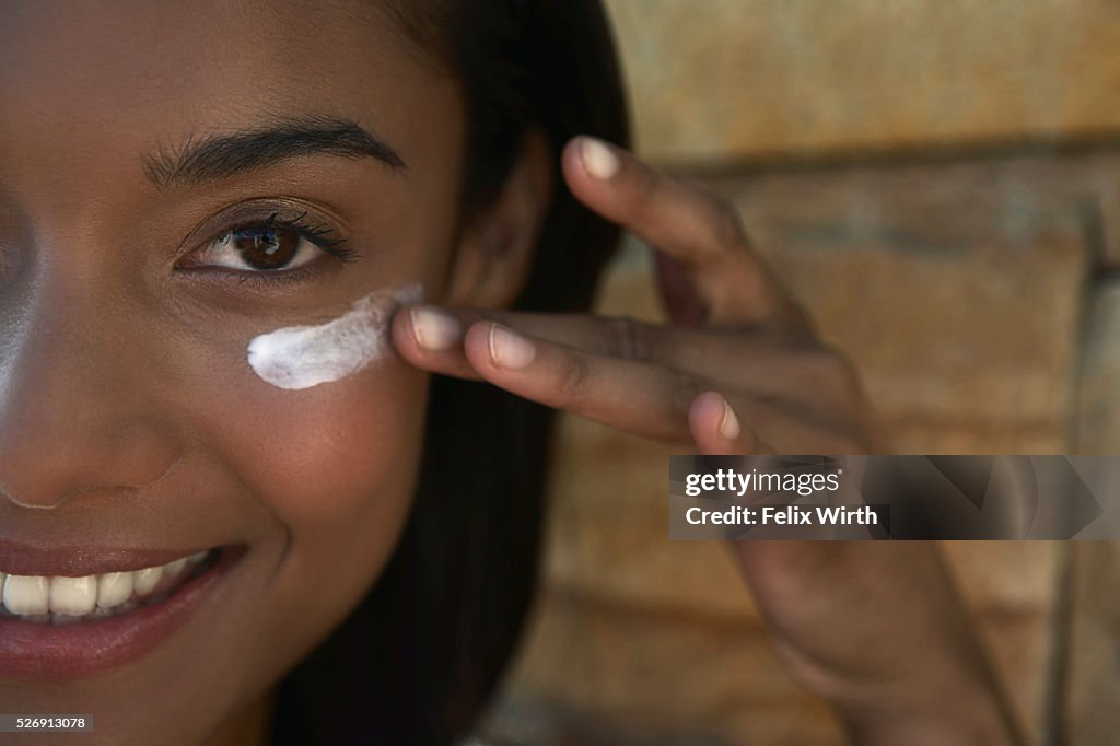 Woman applying sunscreen