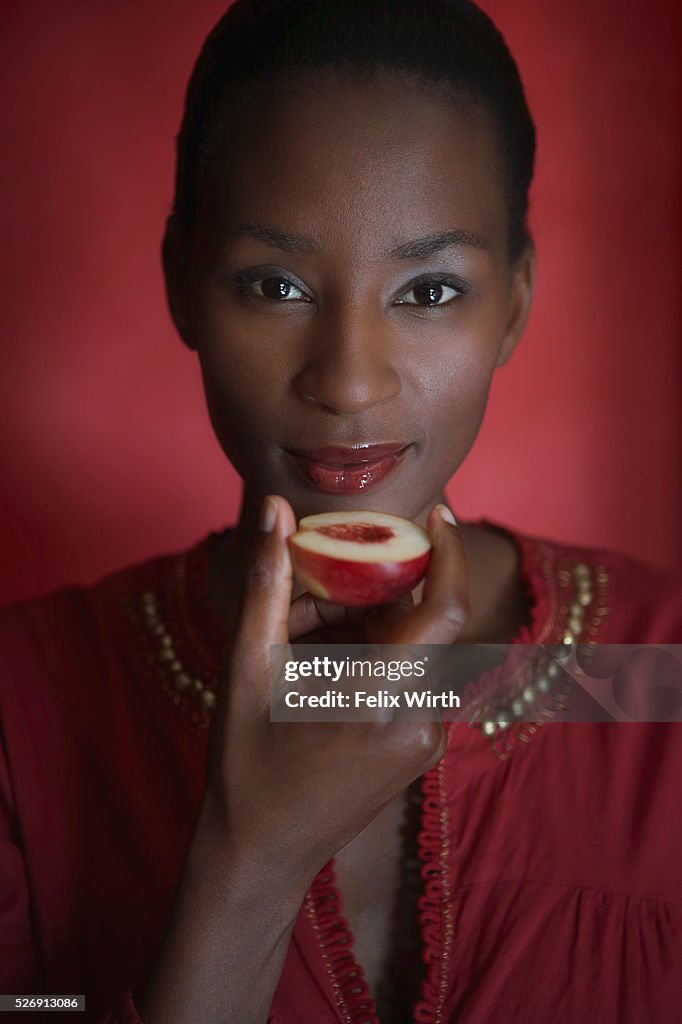 Woman eating a peach