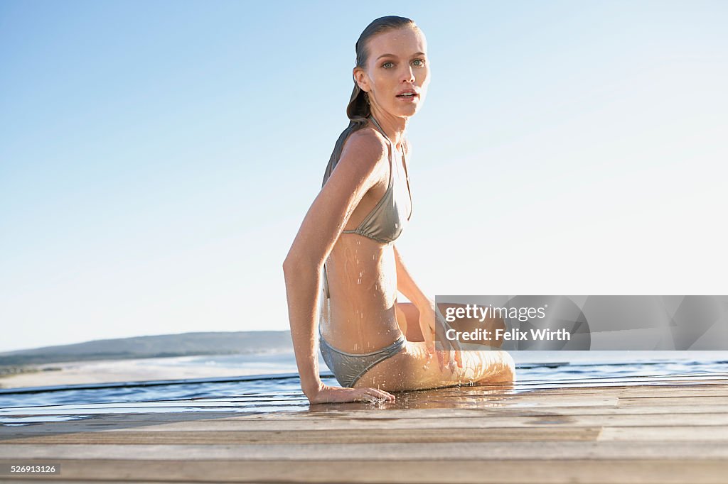 Woman emerging from swimming pool