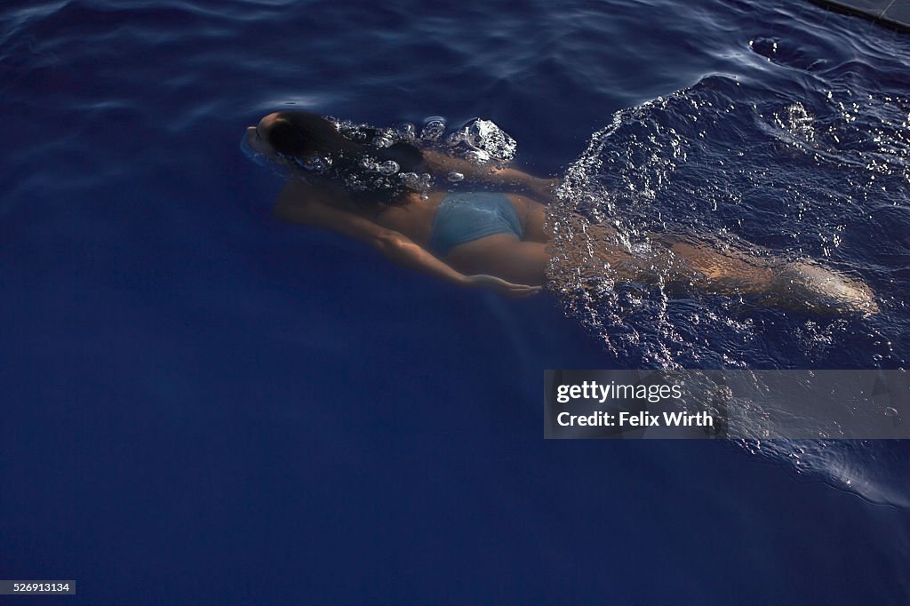 Young woman swimming in pool