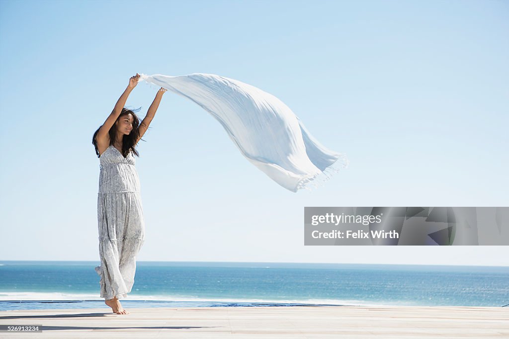 Woman holding shawl in wind