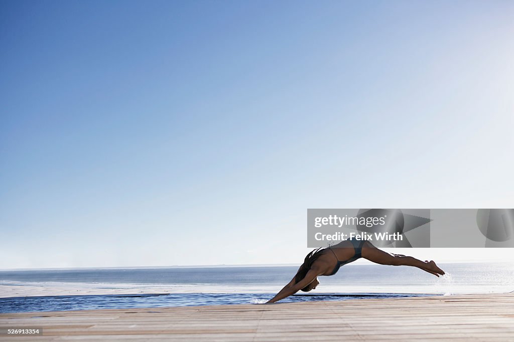 Woman diving into swimming pool