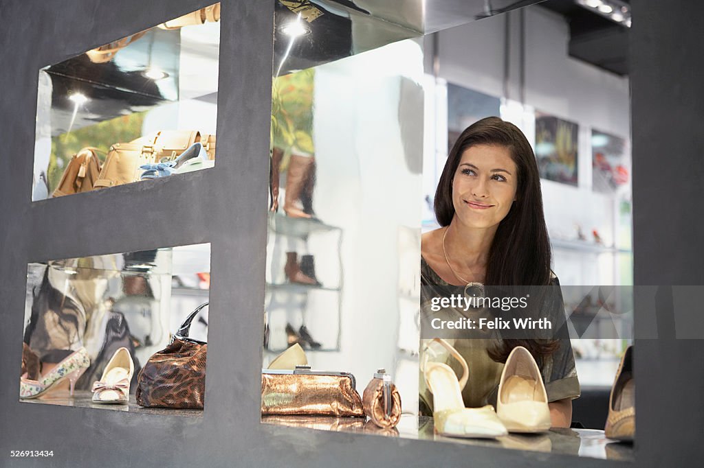 Woman looking out boutique window