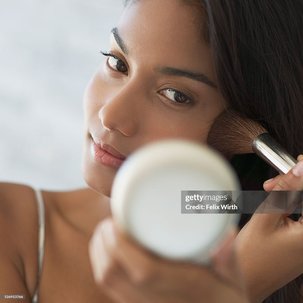 Woman applying make-up