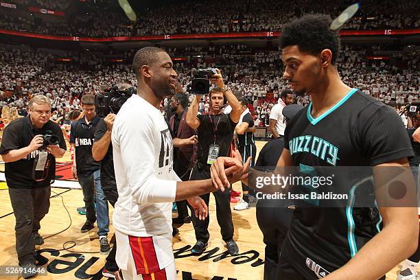 Dwyane Wade of the Miami Heat shakes hands with Jeremy Lamb of the Charlotte Hornets after winning Game Seven of the Eastern Conference Quarterfinals...