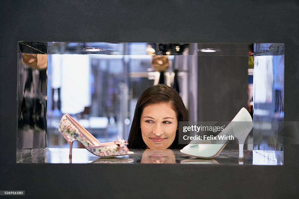 Woman looking at high heel shoes