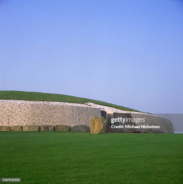 Large flat stones surround the base of the burial mound at Newgrange, a passage grave dating from around 3100 B.C., in County Meath, Republic of...