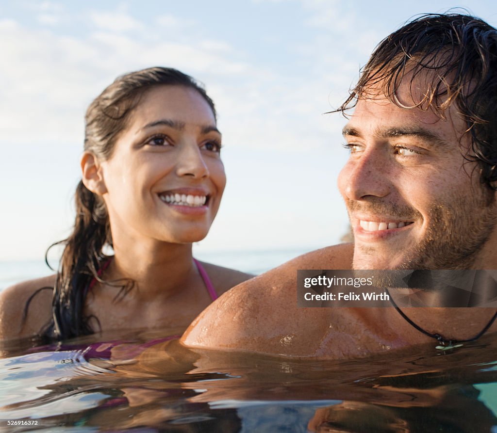 Portrait of couple swimming in sea