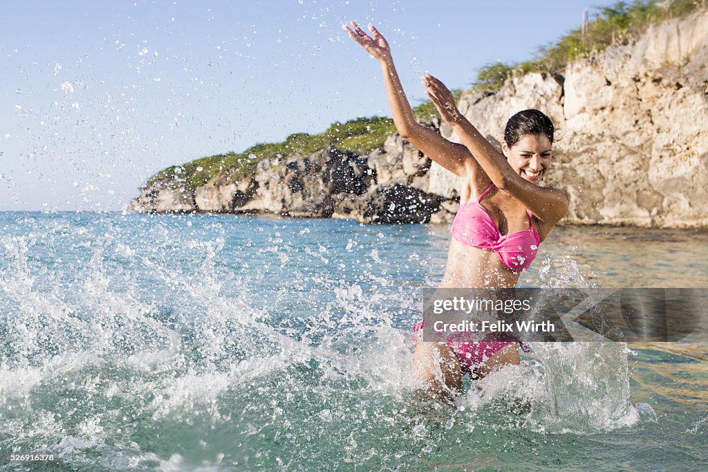 Woman splashing in sea