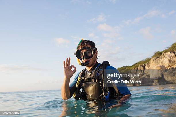 man with scuba diving equipment in sea showing ok sign - ok sign stock pictures, royalty-free photos & images