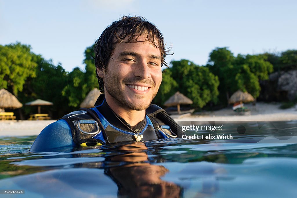 Portrait of man in wetsuit in sea