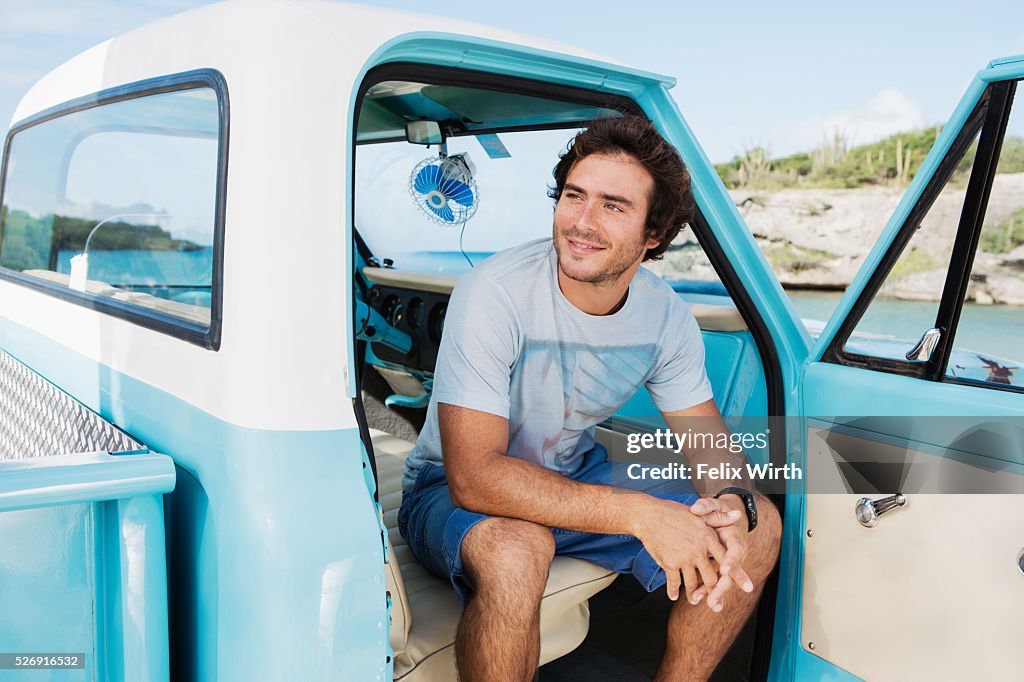 Portrait of man sitting in vintage pickup truck