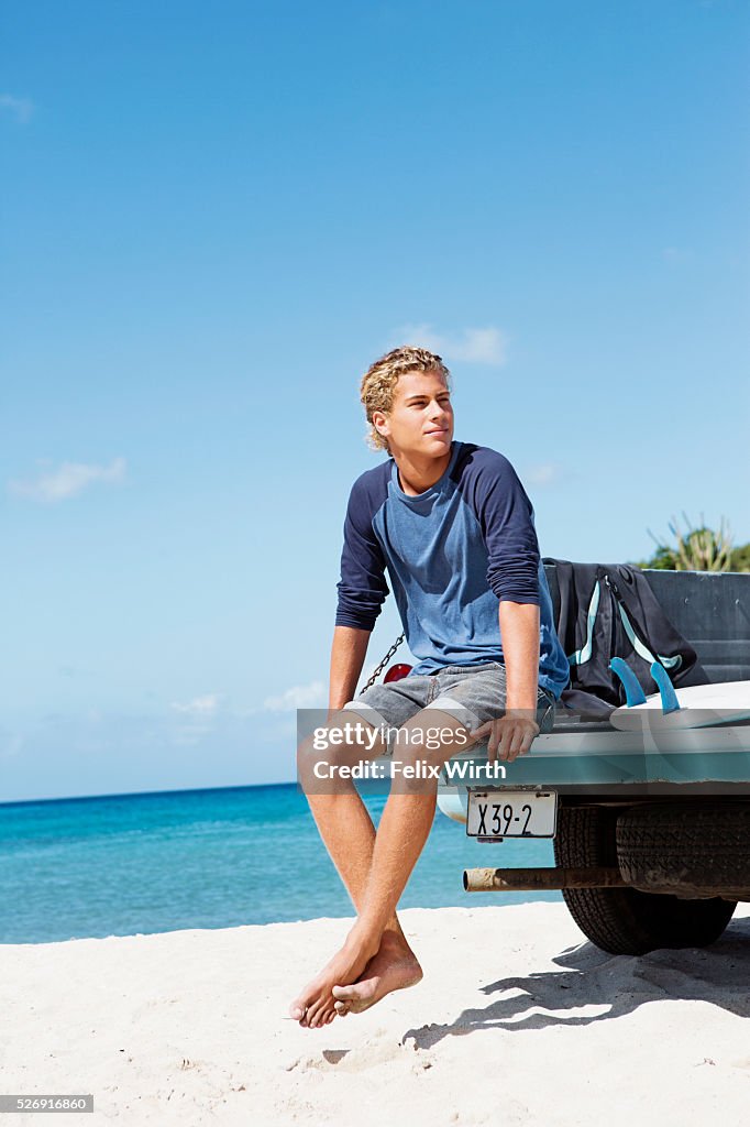 Young man sitting on trailer