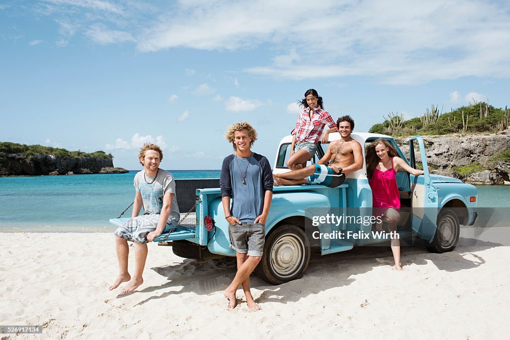 Group of friends with truck on beach