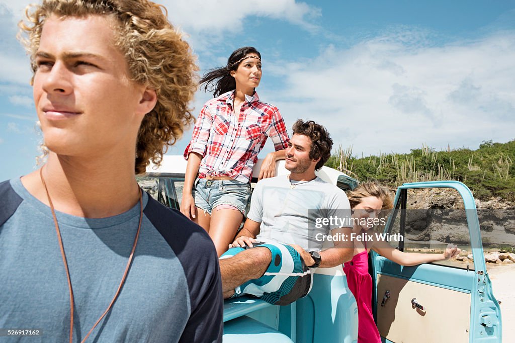 Group of friends with truck on beach