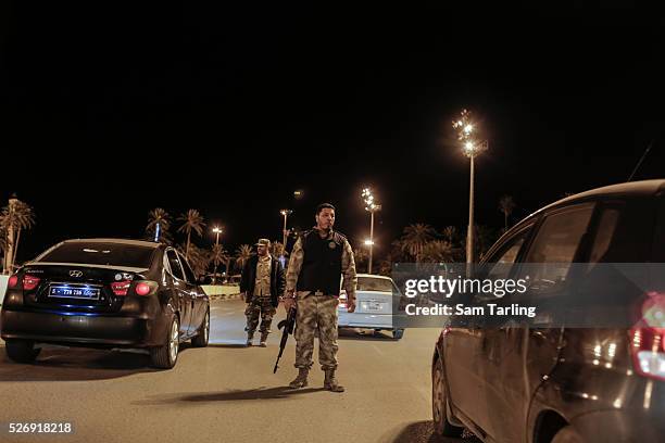 Policemen belonging to the Nawasi brigade, which is part of the Tripoli-based Libyan General National Congress government's Interior Ministry conduct...