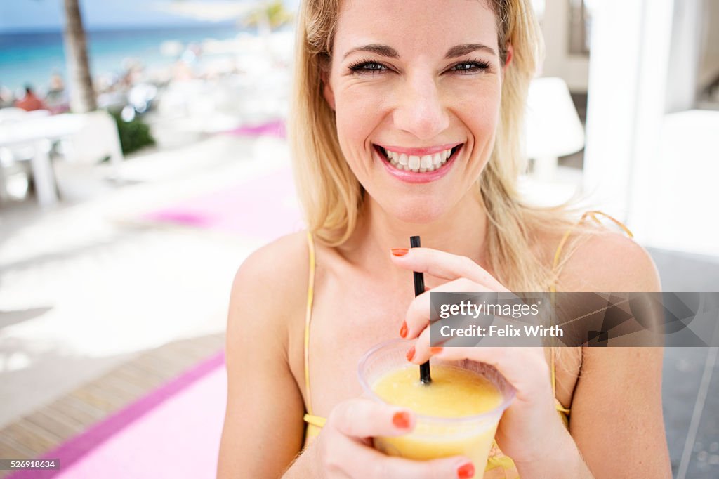 Portrait of woman relaxing at cafe nearby beach