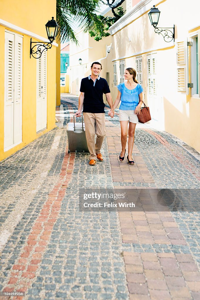 Couple walking along cobblestone street