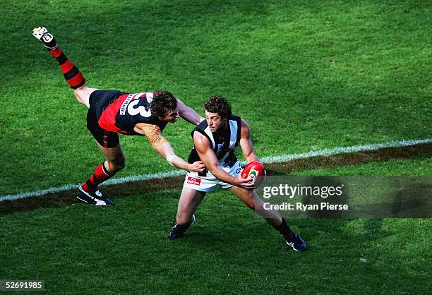 Mark Bolton for the Bombers tackles Shane O'Bree for the Magpies during the round five AFL match between the Essendon Bombers and the Collingwood...