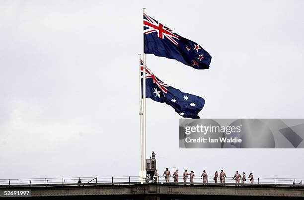 Bridgewalkers stand under the Australian flag and for the first time, the New Zealand flag as they fly on the Sydney Harbour Bridge to commemorate...