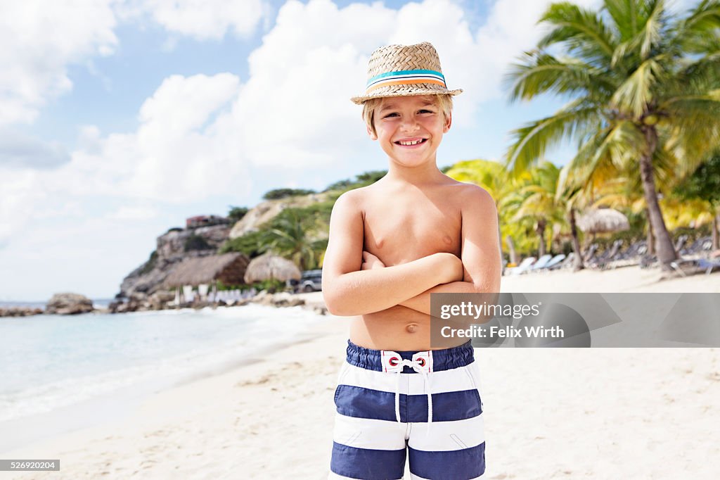 Portrait of boy (4-5) standing on beach