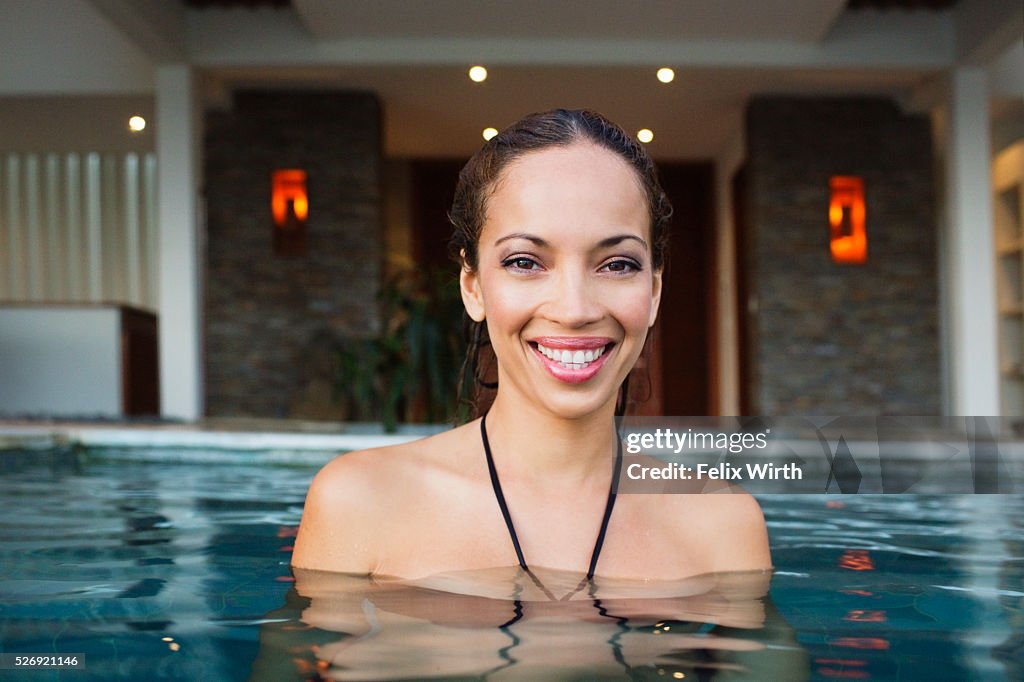 Young woman bathing in swimming pool