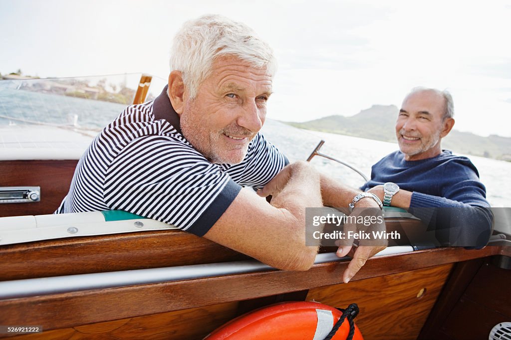 Two senior friends in motorboat