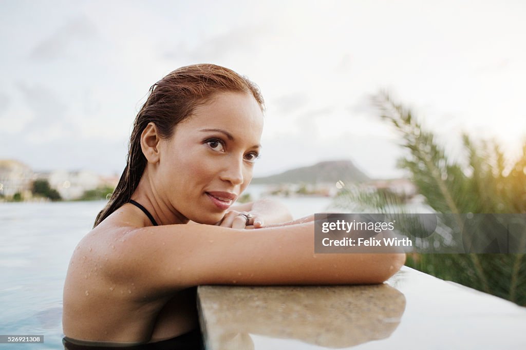 Young woman bathing in swimming pool