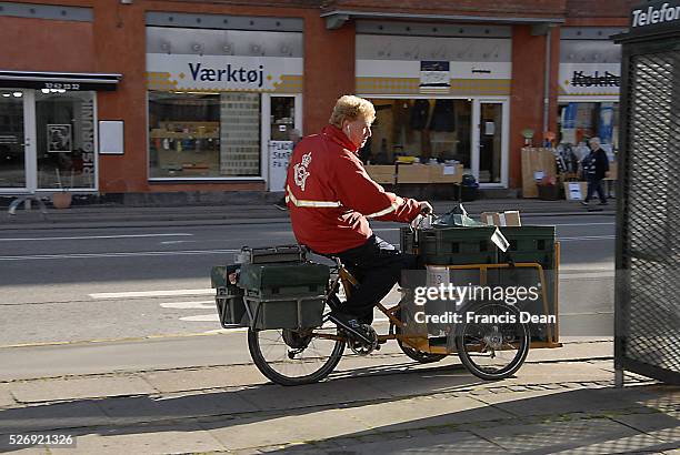 Copenhagen/Denmark/ 25th September 2015_ Postman on his 3 wheels electric bike