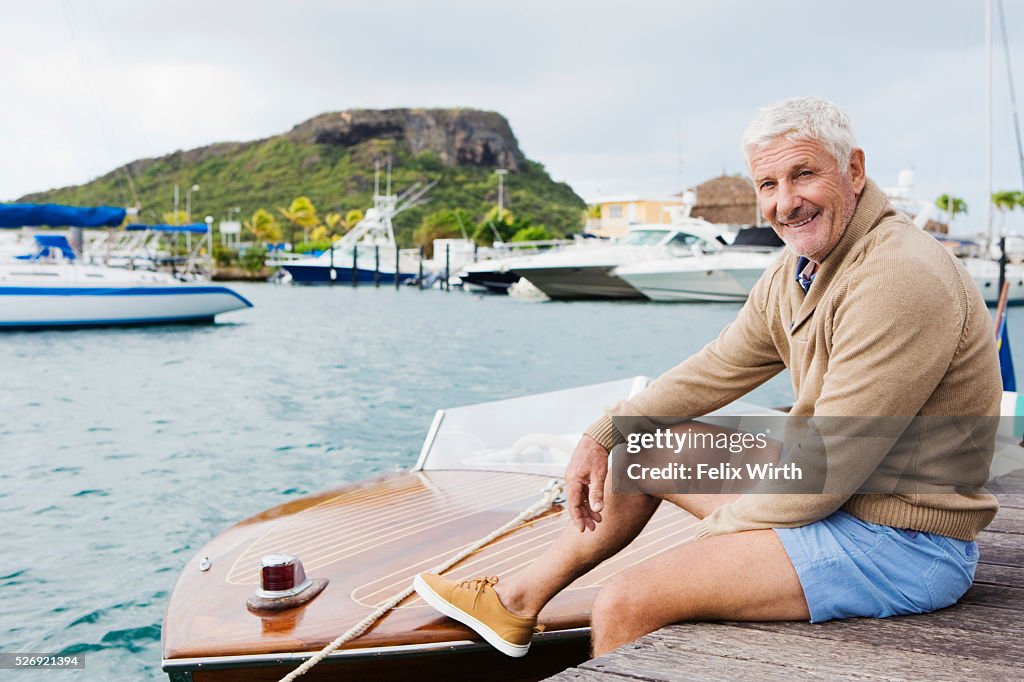 Senior man sitting on jetty