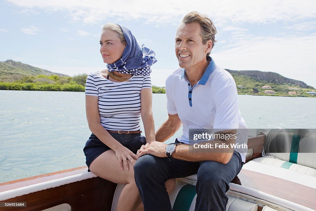 Couple relaxing on motorboat