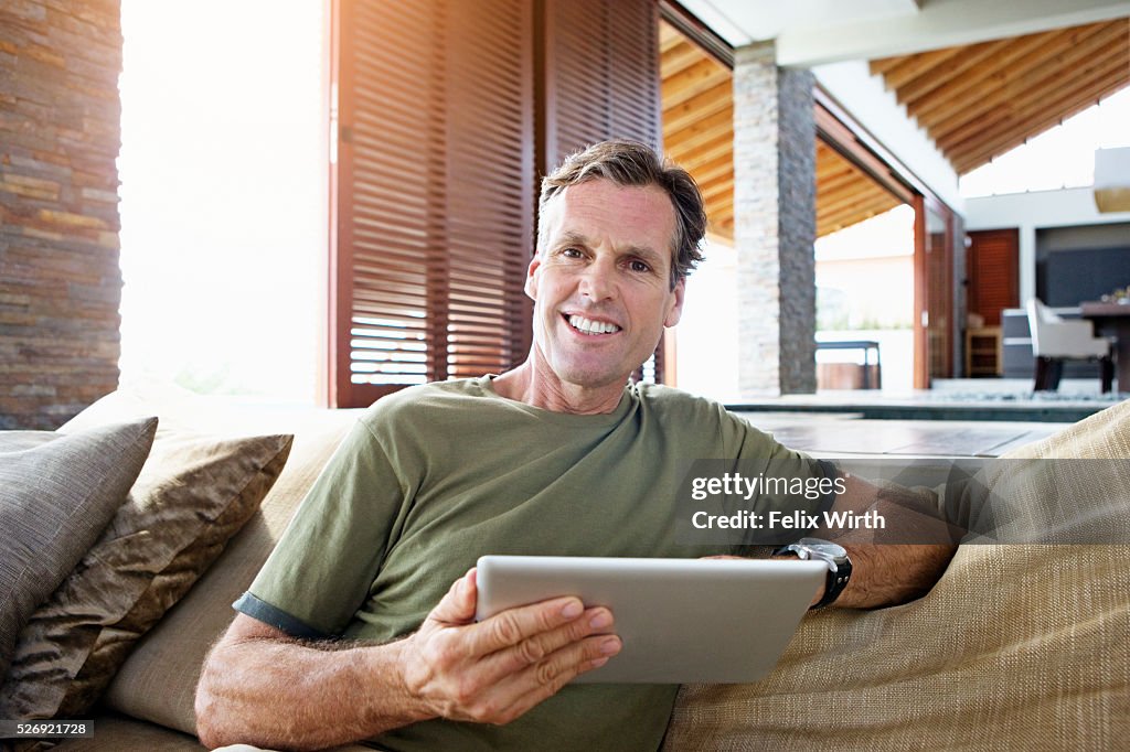 Man using tablet pc at home