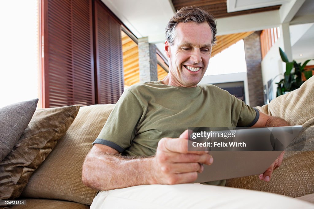 Man using tablet pc at home