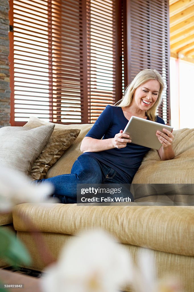 Woman using tablet pc at home