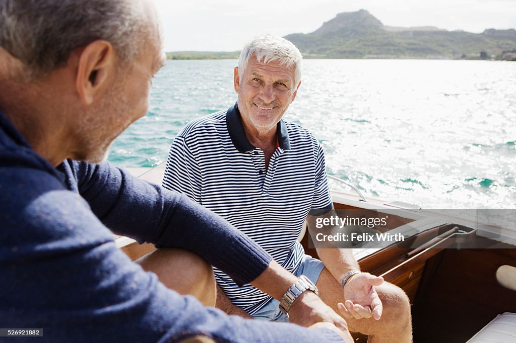 Two senior friends in motorboat