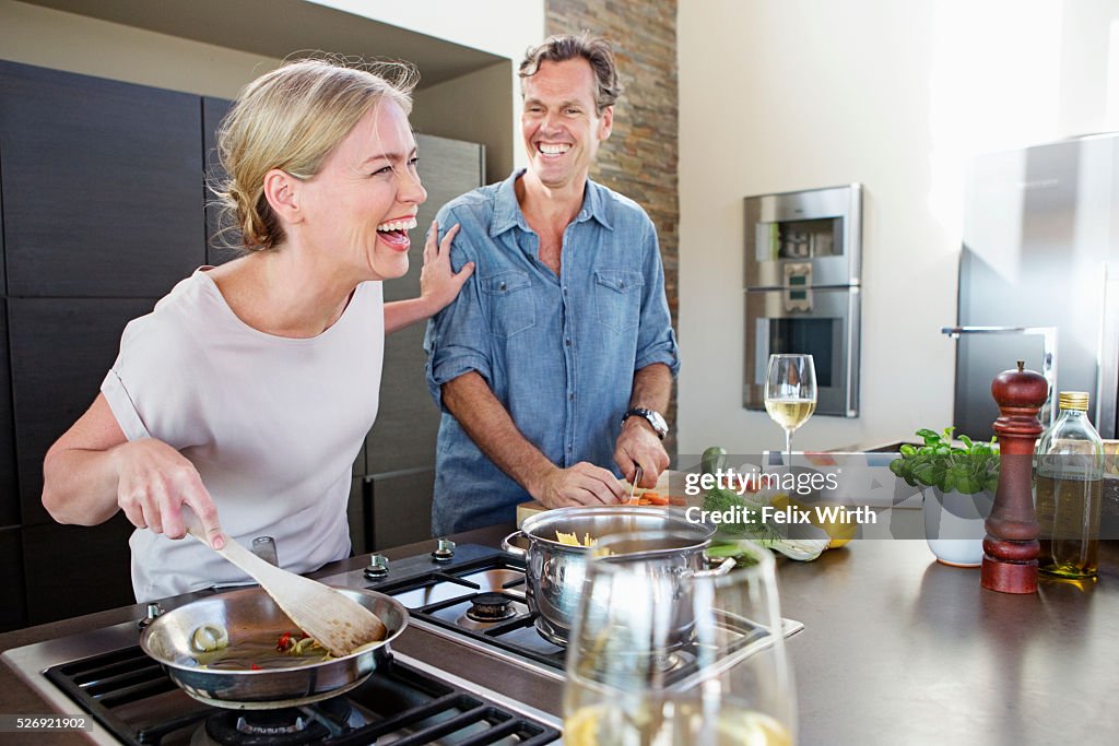 Middle-aged couple cooking together