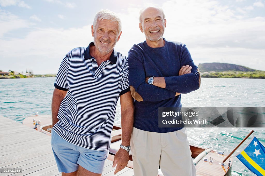 Two senior men standing on jetty