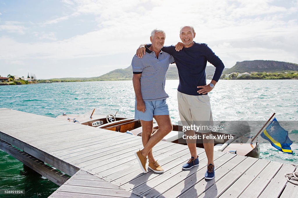 Two senior men standing on jetty