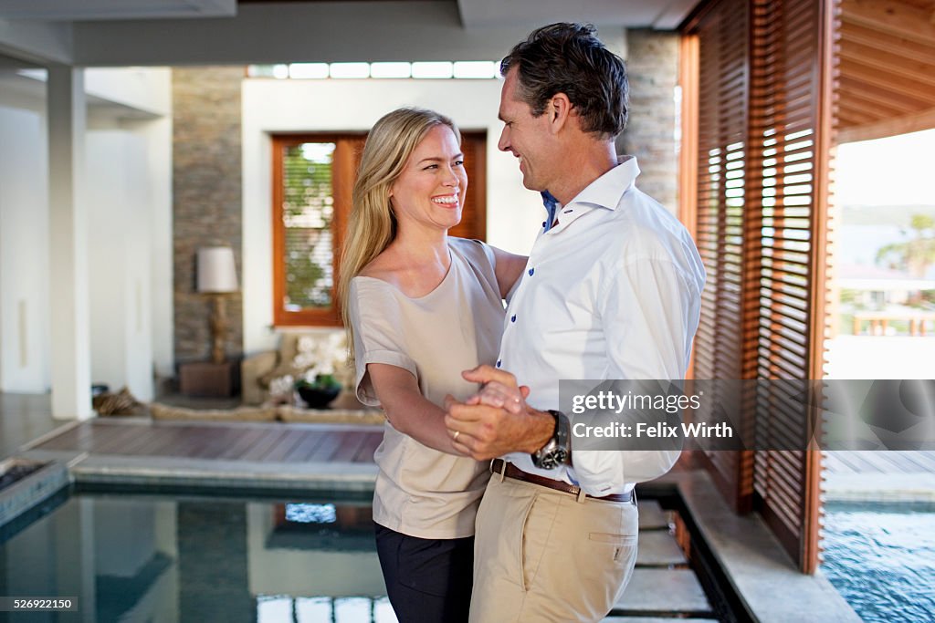 Middle-aged couple dancing at home