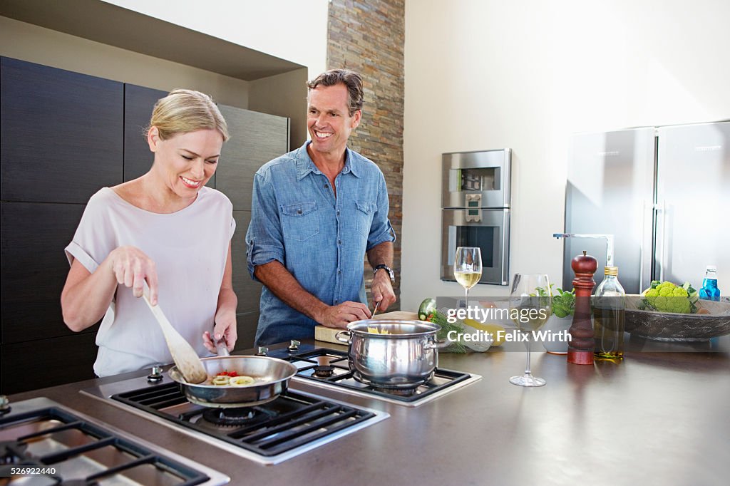 Middle-aged couple cooking together