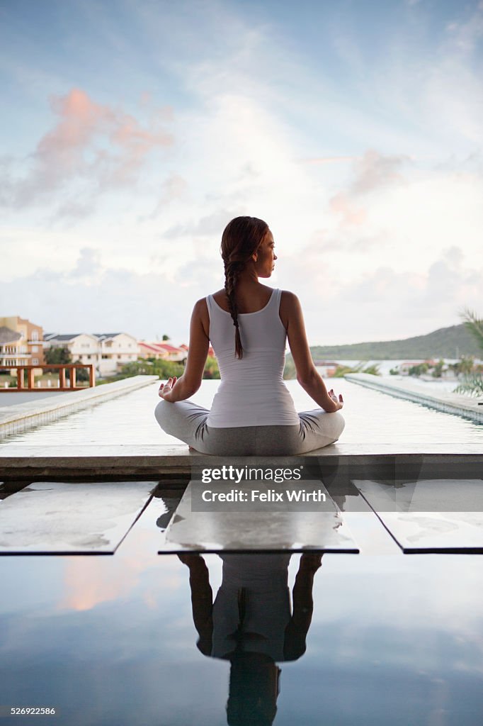 Young woman doing yoga on patio