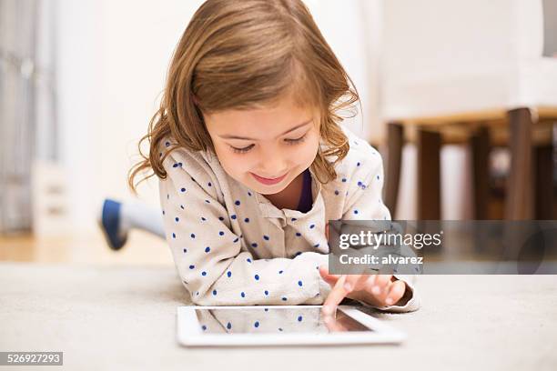 little girl learning using digital tablet - small smart girl stock pictures, royalty-free photos & images