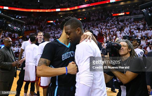 Miami Heat guard Dwyane Wade hugs Charlotte Hornets guard Courtney Lee after Game 7 of the first round of the 2016 NBA Eastern Conference Playoffs on...
