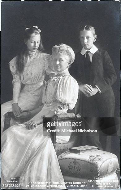 Augusta Victoria, the Empress of Prussia and Germany, poses with her two youngest children - Princess Victoria Louise and Prince Joachim.